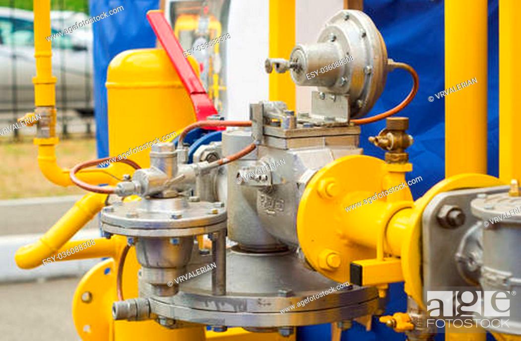 Stock Photo: ellow gas pressure regulator with a crane and gear.