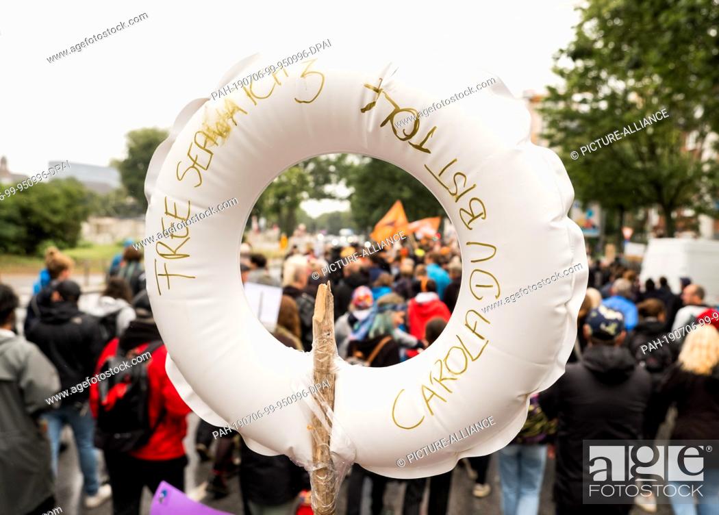 Stock Photo: 06 July 2019, Hamburg: Participants of a demonstration in solidarity with the captain of the German rescue ship ""Sea-Watch 3"", C.
