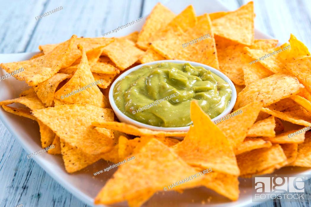 Stock Photo: Nachos with Guacamole (close-up shot) on wooden background.