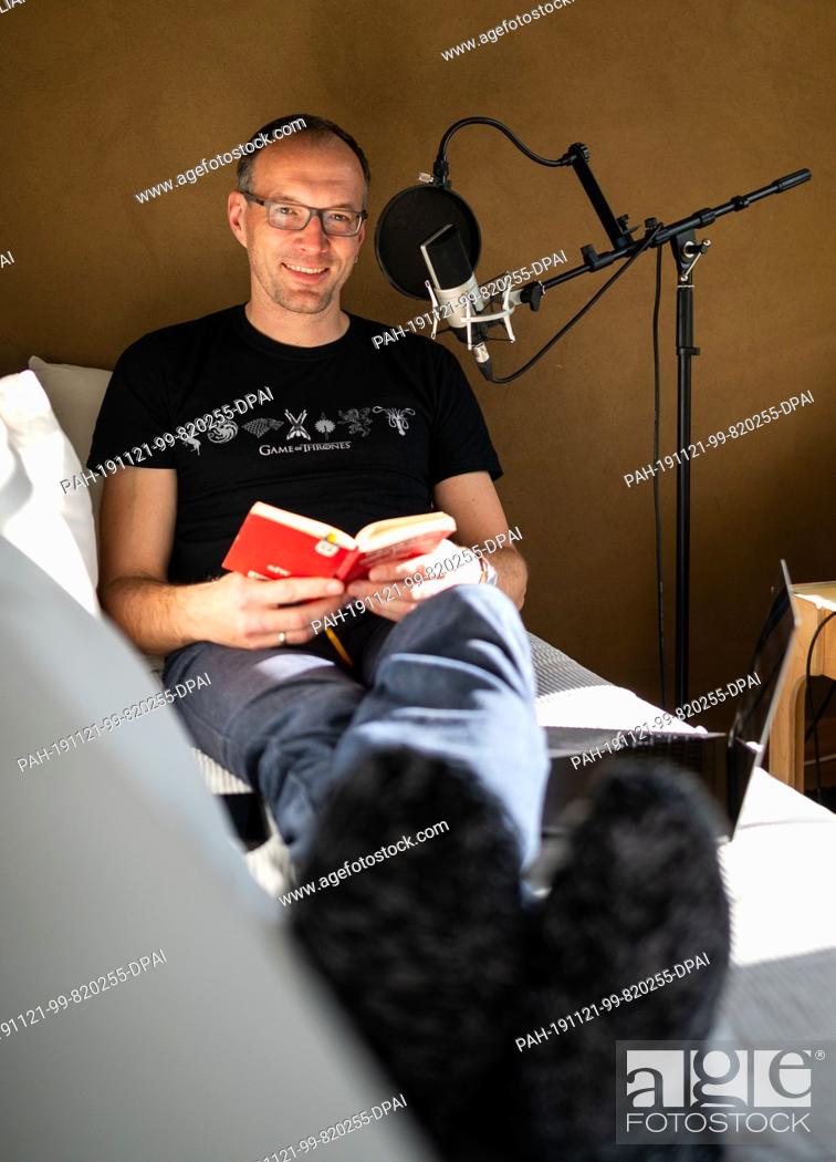 Stock Photo: 29 October 2019, Lower Saxony, Kakenstorf: Toby Baier, ""falling asleep"" podcaster, sits in his study and is in the process of making a new contribution.