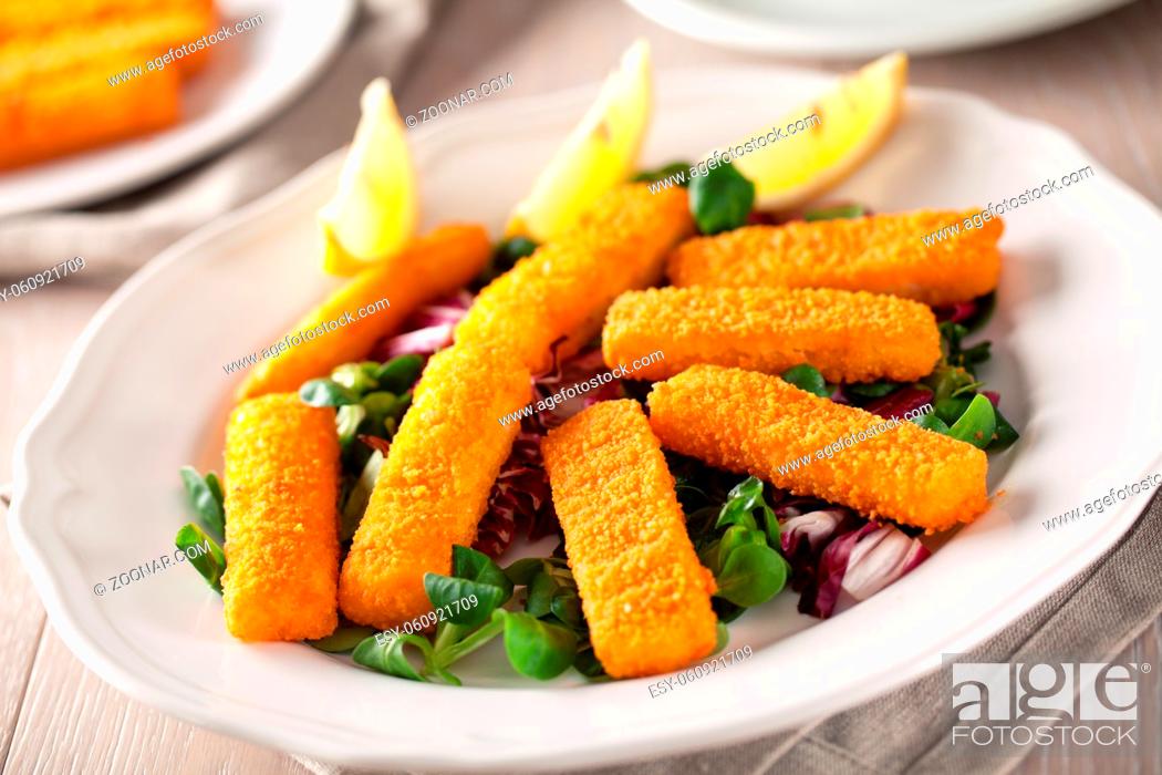 Stock Photo: Fresh breaded fish fingers served with mixed salad.