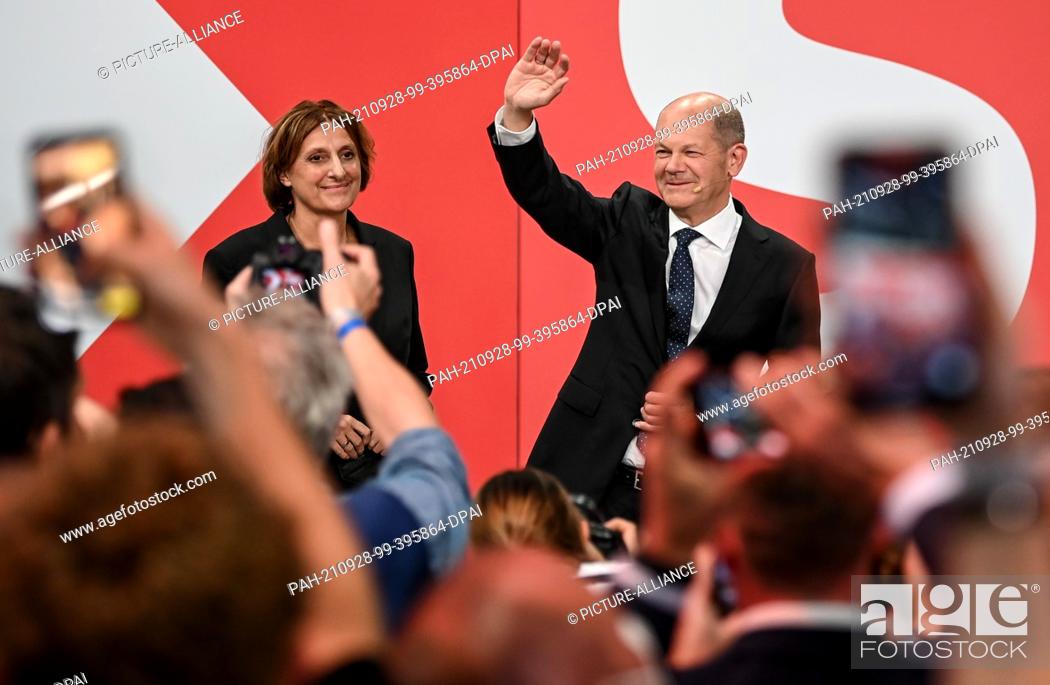 Stock Photo: 26 September 2021, Berlin: Olaf Scholz, Finance Minister and SPD candidate for Chancellor, waves next to his wife Britta Ernst during the election party at.