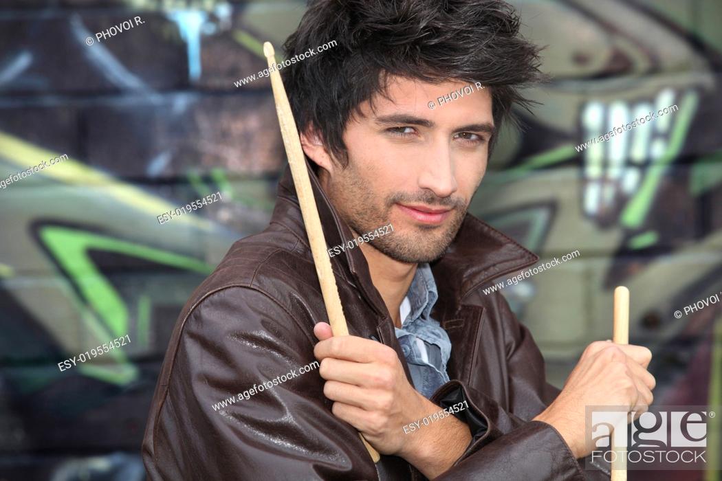 Stock Photo: Drummer standing in front of graffiti.