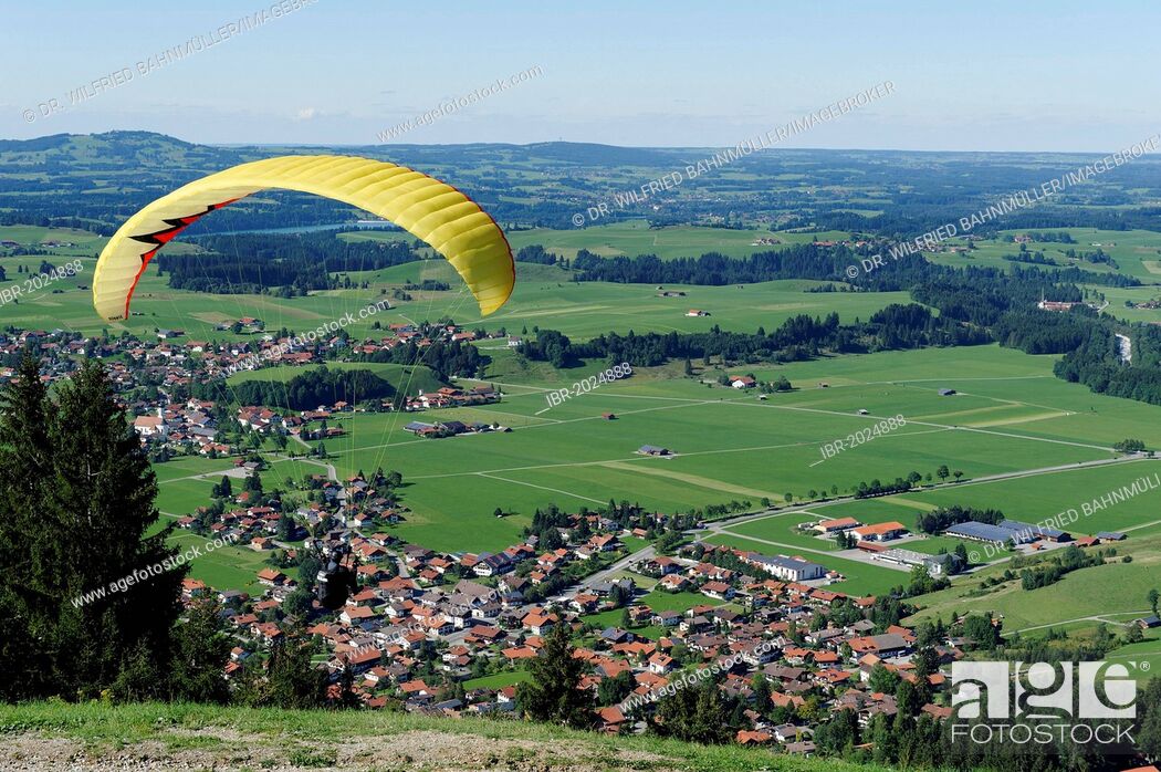 Stock Photo: Paraglider gliding from Buchenberg Mountain above Buching, East Allgaeu, Swabia, Bavaria, Germany, Europe.
