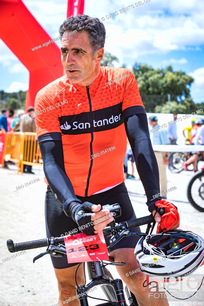 Stock Photo: Former cyclist Miguel Induráin at the end of the race in Madrid, Spain Jun 13, 2020. The former Tour de France winner cyclist competes in a MTB time trial in.
