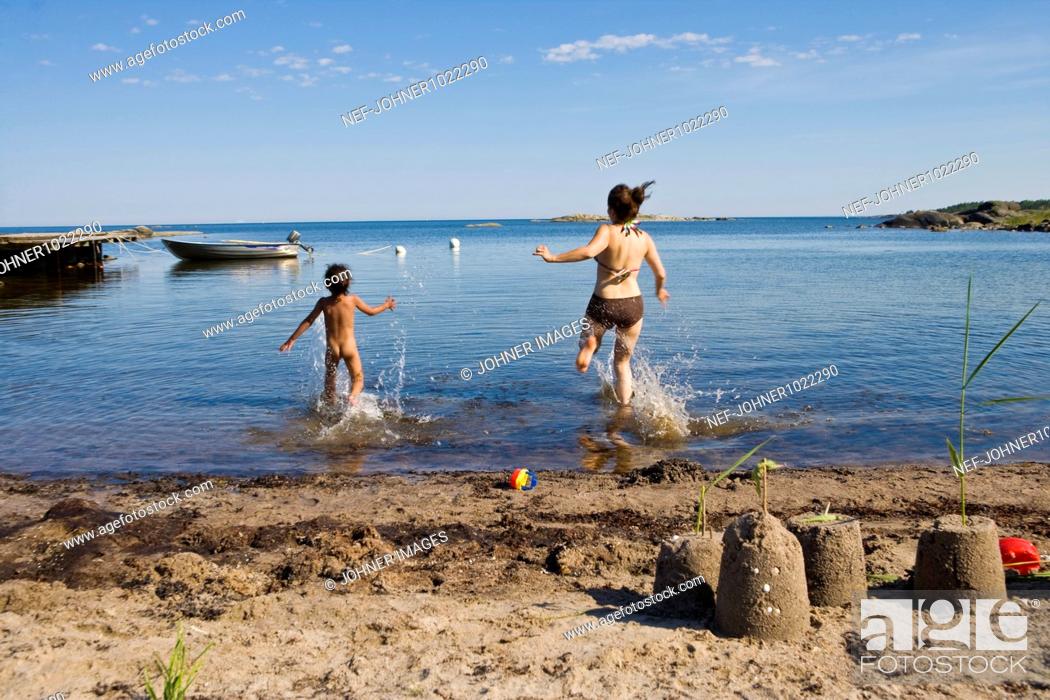 1050px x 700px - Scandinavia, Sweden, Grisslehamn, rear view of mother and daughter on beach  running towards sea, Stock Photo, Picture And Royalty Free Image. Pic.  NEF-JOHNER1022290 | agefotostock