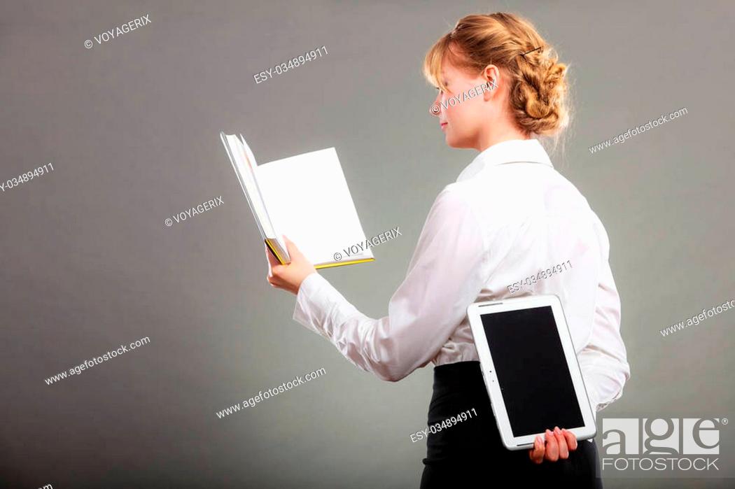 Stock Photo: Woman learning with book holding ebook reader behind back. Choice between modern educational technology and traditional way method.