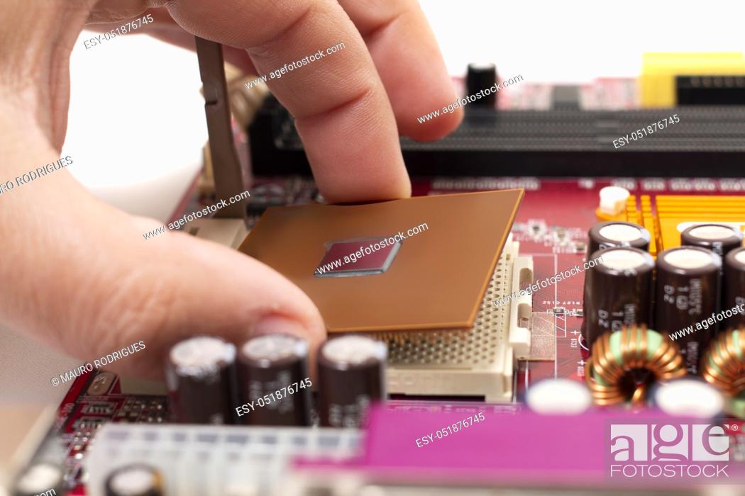 Stock Photo: Close up view of the mounting of a cpu on motherboard.