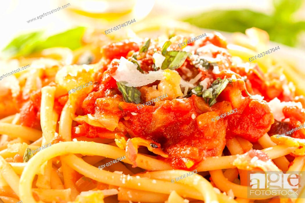Stock Photo: Homemade Bucatini Amatriciana Pasta with sauce and basil.