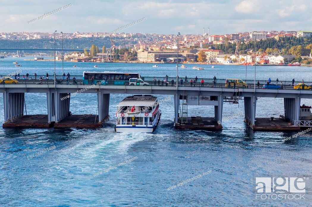 Stock Photo: Ferry boat ship passes under the Unkapani Bridge at Golden Horn bay, Istanbul, Turkey.