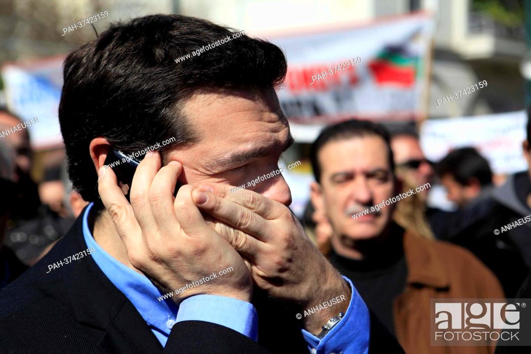 Stock Photo: Alexis Tsipras of the Coalition of the Radical Left - Unitary Social Front (SYRIZA) talks on the phone during a general strike in Athens, Greece.