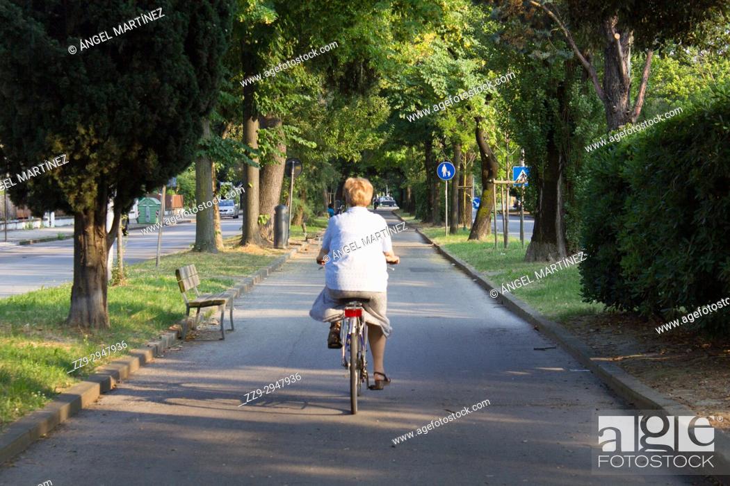 Stock Photo: woman cycling in marghera, Italy.