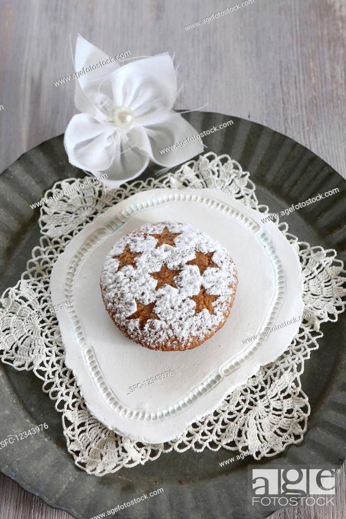 Stock Photo: Homemade gingerbread with icing sugar dusted in a star pattern, on a lace doily (gluten-free).