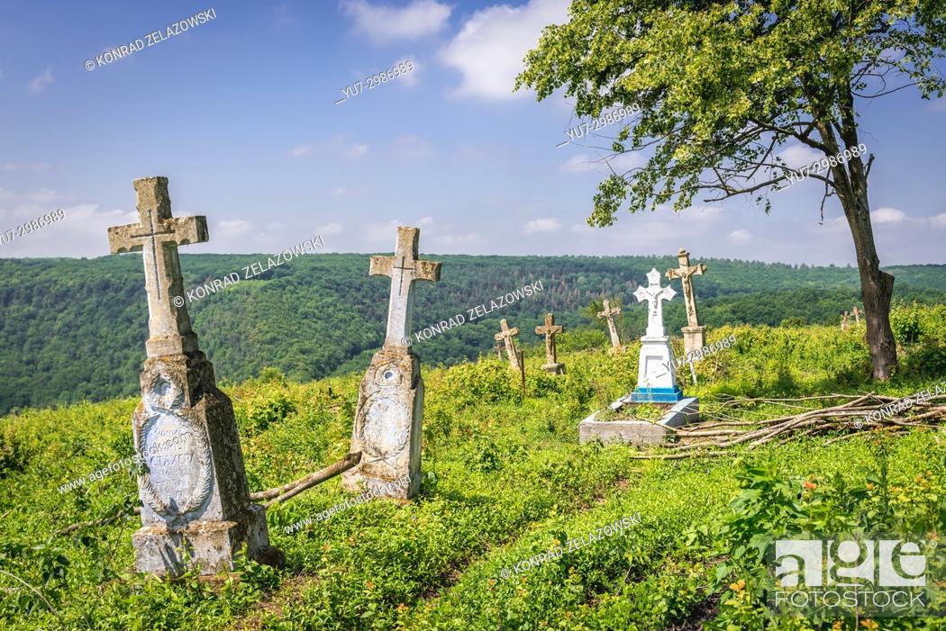 Stock Photo: Old graves on a abandoned cemetery near ruined castle in former Chervonohorod village in Zalischyky region, Ternopil Province, Ukraine.