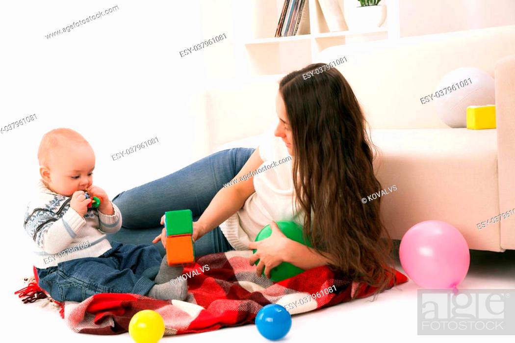 Stock Photo: mother and son playing in room.