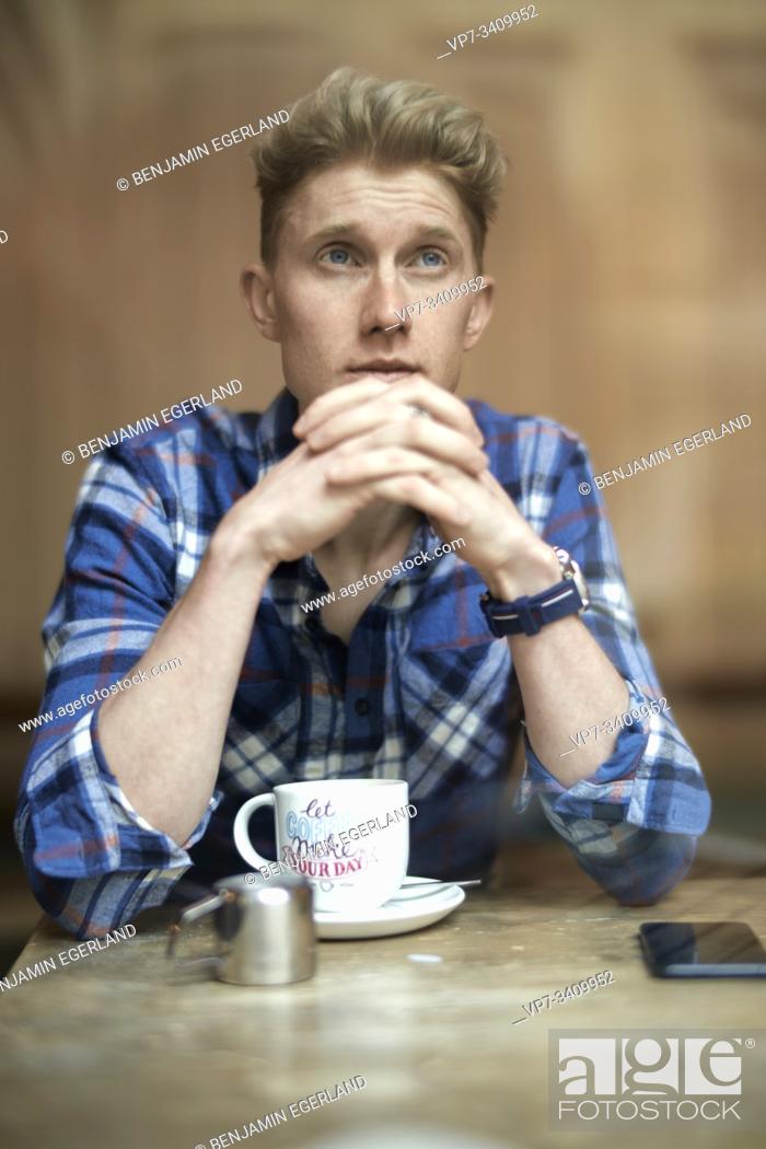 Stock Photo: Young man in cafe, Munich, Germany.