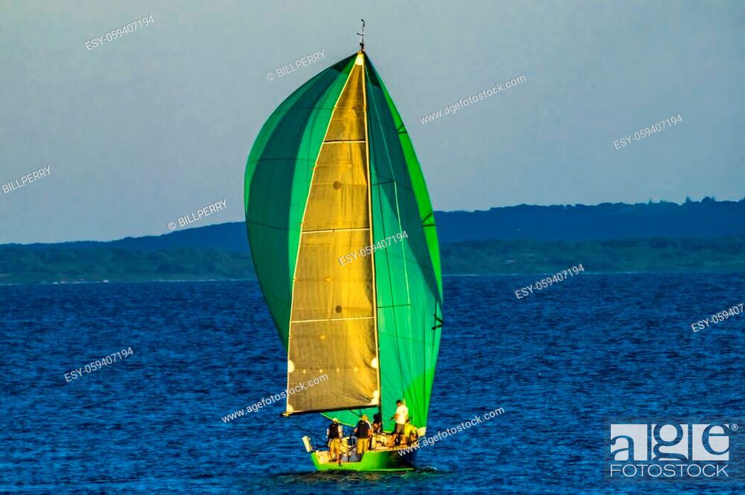 Stock Photo: Colorful Green Sailboat Spinnaker Racing Padanaram Harbor Buzzards Bay Dartmouth Masschusetts.