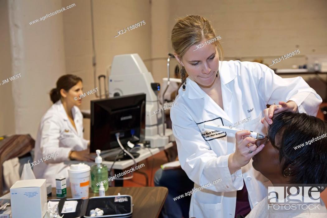 Stock Photo: Detroit, Michigan - Health care providers offered free screenings for eye, dental, and other health problems at a community health fair  An eye care.
