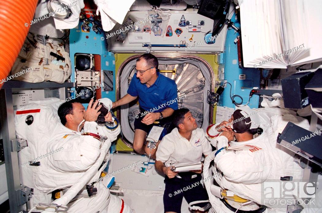 Stock Photo: Astronauts Michael E. Lopez-Alegria (left) and John Herrington, both STS-113 mission specialists, assisted by astronauts Donald R.
