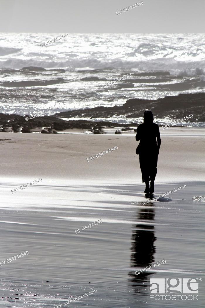 Stock Photo: View of one silhouette walking the beach on the Algarve, Portugal.
