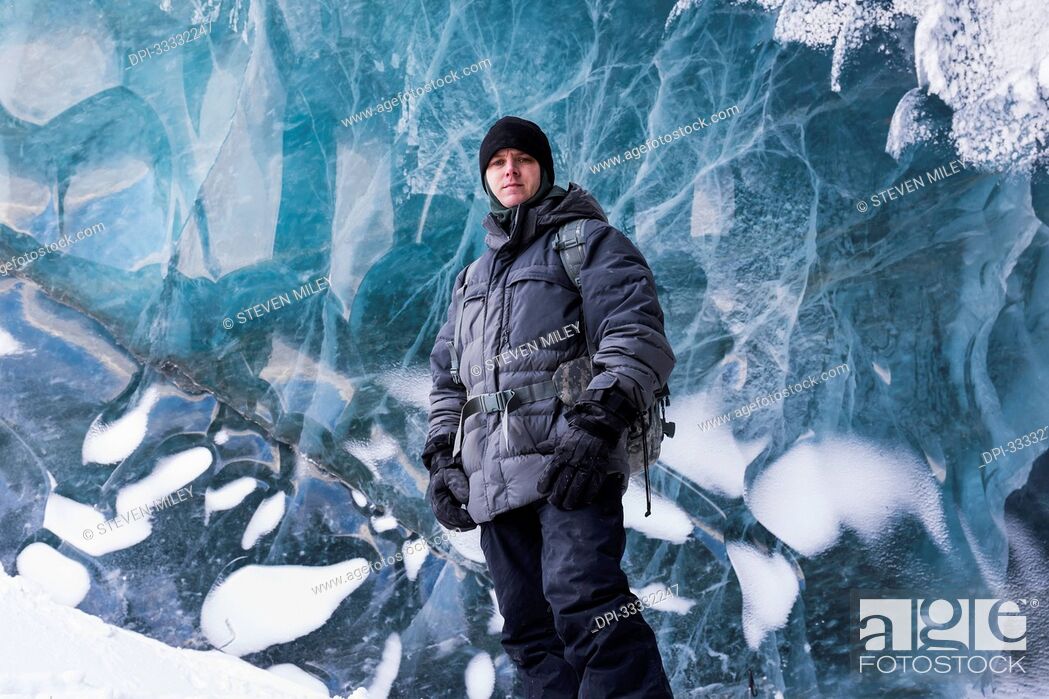 Stock Photo: Portrait of a Fort Greely soldier standing in front of the glacial ice inside a cave on the Canwell Glacier in the Delta Mountains; Alaskan Range, Alaska.