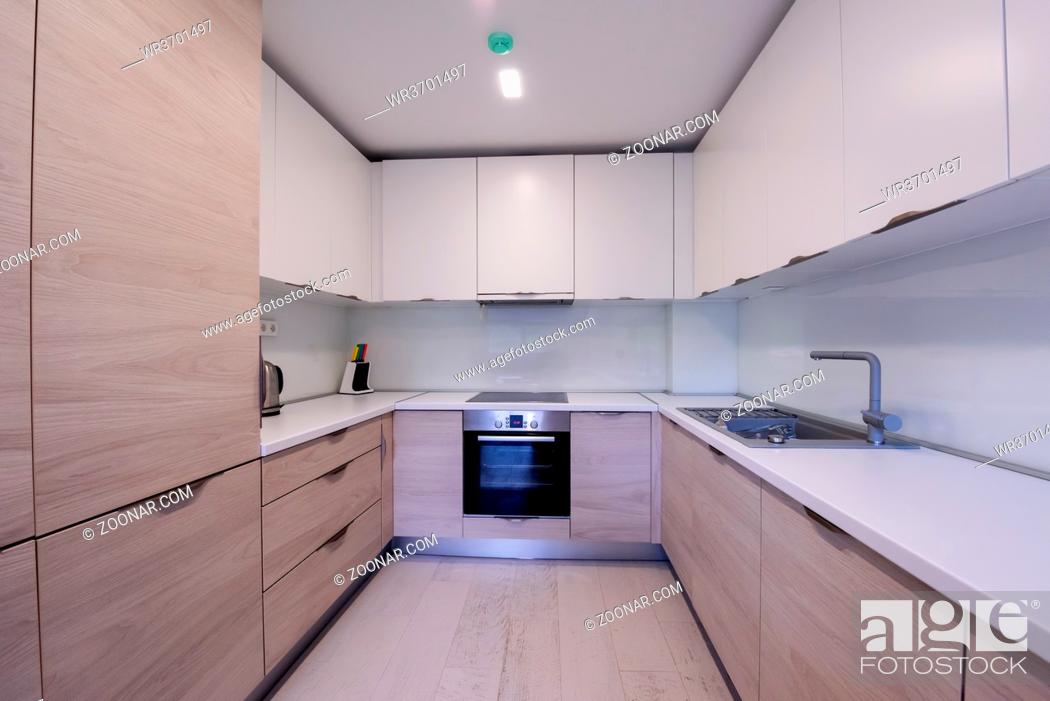 Stock Photo: Beautiful modern bright clean kitchen interior in new luxury home with wooden cupboards.
