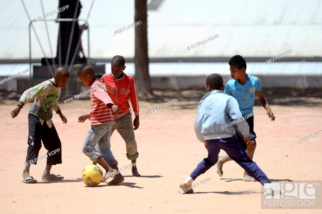 Stock Photo: Madagaskar, Fianarantsoa, Street boys playing soccer in school yard.