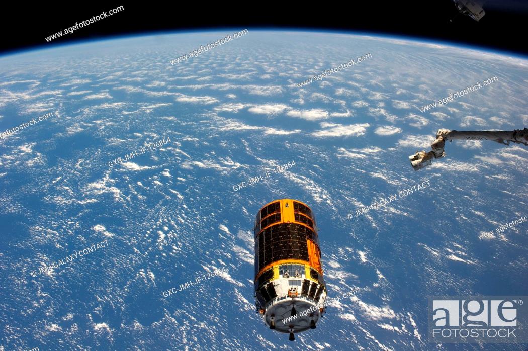 Stock Photo: Backdropped by a blue and white part of Earth, the unpiloted Japan Aerospace Exploration Agency's Kounotori2 H-II Transfer Vehicle (HTV2).