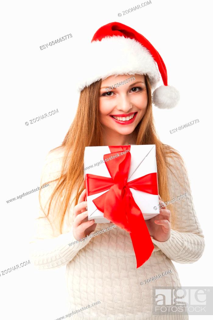 Imagen: Christmas Santa hat isolated. Woman hold christmas gift. Smiling happy girl on white background.