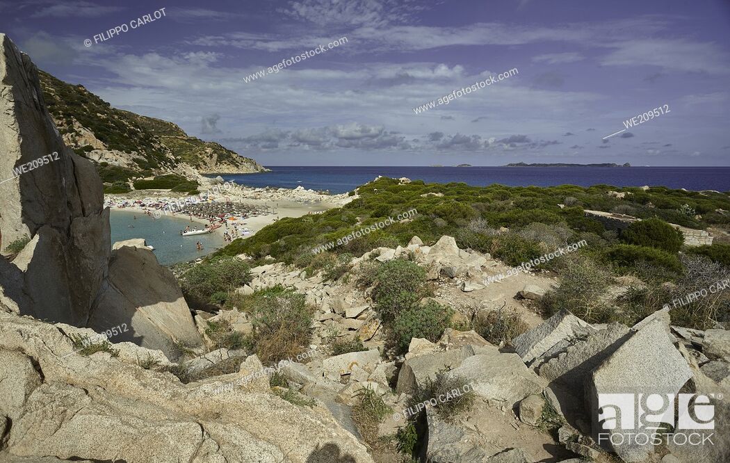 Stock Photo: View filtered by limestone rocks of the beach of Punta Molentis in the southern coast of Sardinia: a corner of paradise.