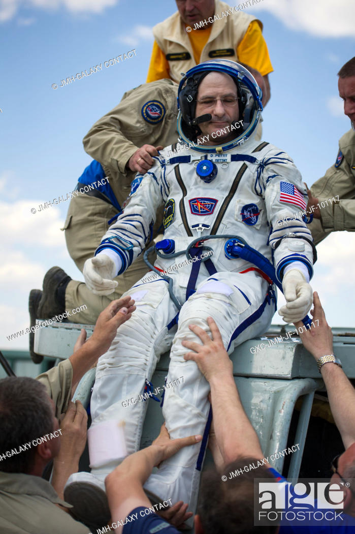 Stock Photo: Expedition 31 Flight Engineer Don Pettit of NASA is helped out of the Soyuz TMA-03M capsule after he and Expedition 31 Commander Oleg Kononenko of Russia.