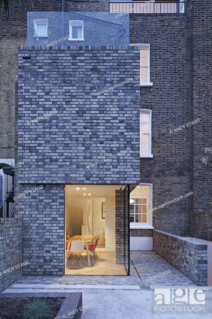 Stock Photo: Extension view at dusk with lit interiors. Queens House, London, United Kingdom. Architect: Paul Archer Design - Architects & Design, 2021.