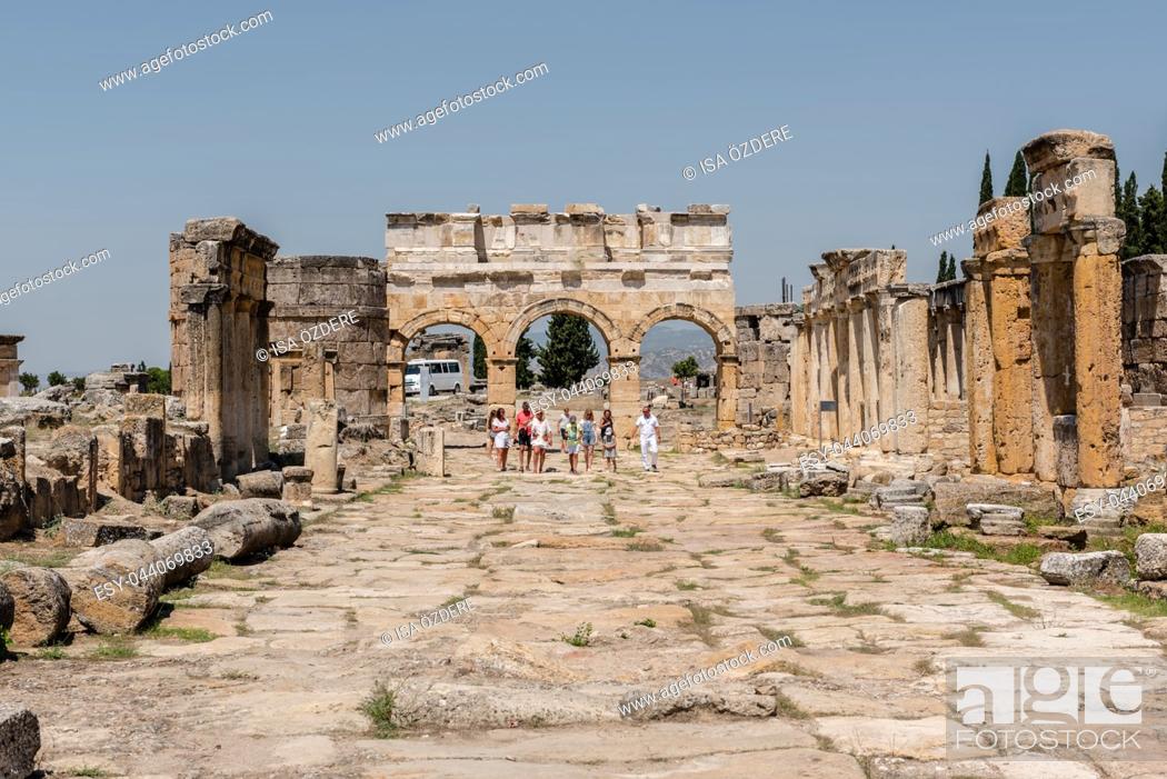 Stock Photo: People visit latrine along Frontinus Street at Hierapolis ancient city in Pamukkale, Turkey. 25 August 2017.