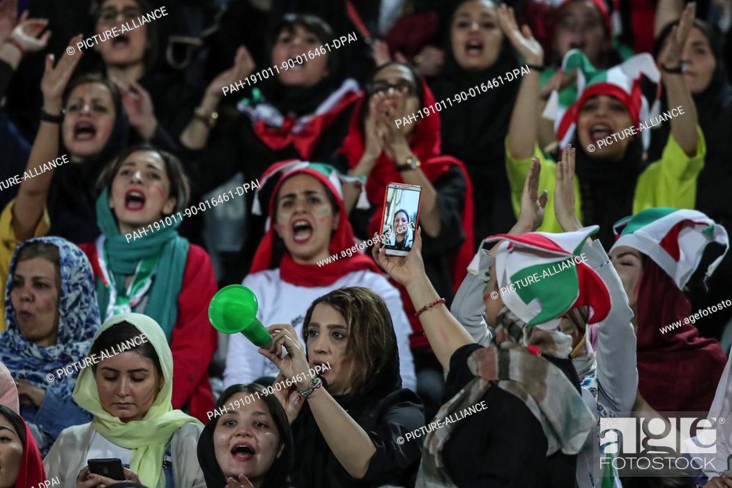 Stock Photo: 10 October 2019, Iran, Tehran: Iranian women attend the FIFA soccer World Cup qualification match between Iran and Cambodia at the Azadi Stadium.