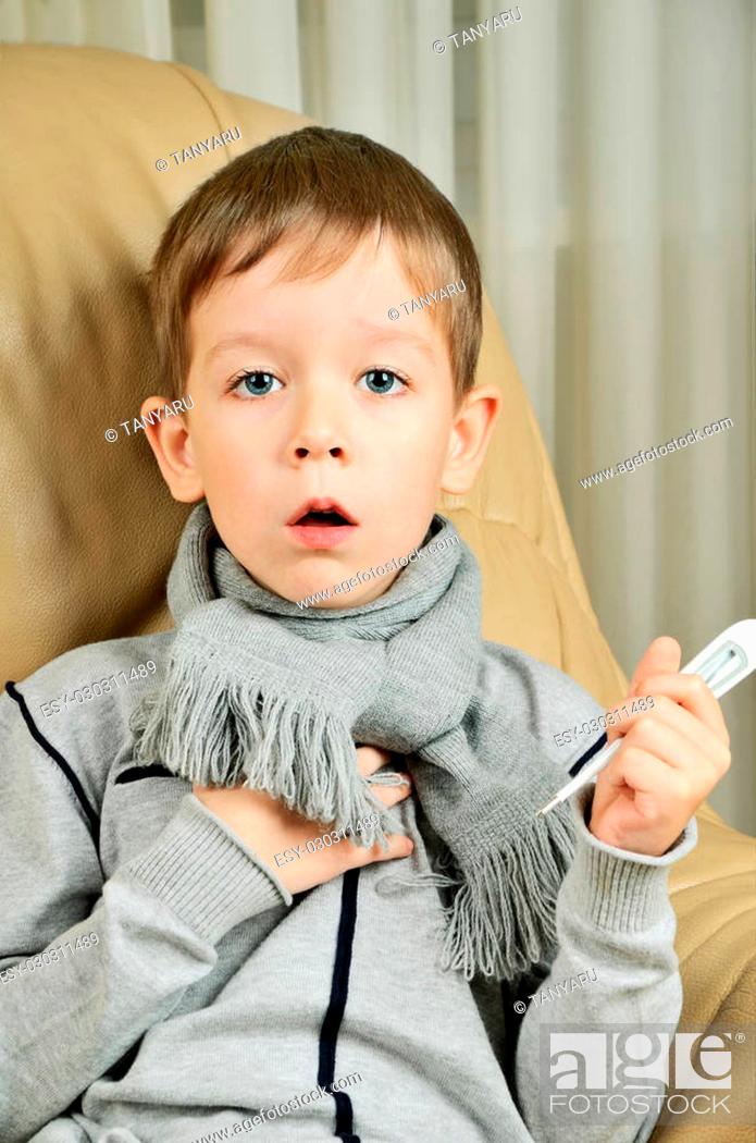 Stock Photo: boy coughing and holding a thermometer vertical.