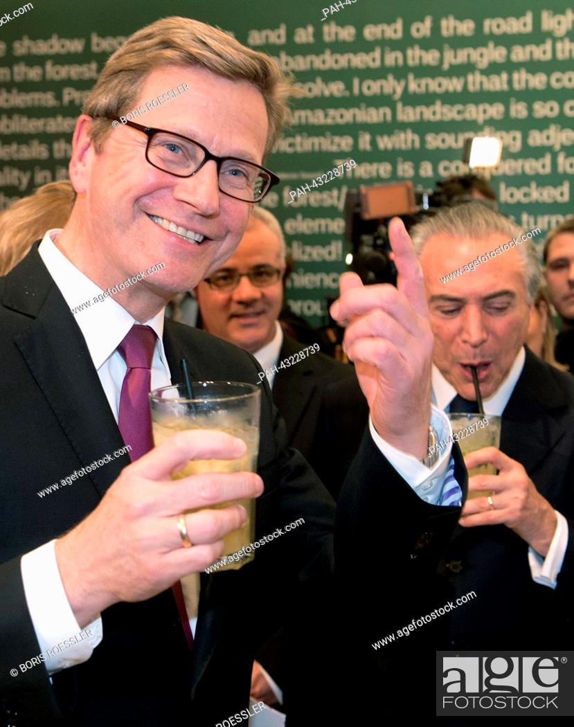 Stock Photo: German Foreign Minister Guido Westerwelle (L) and Vice President of Brazil Michel Temer drink a cocktail as they visit the Pavilion of Brazil at the Frankfurt.