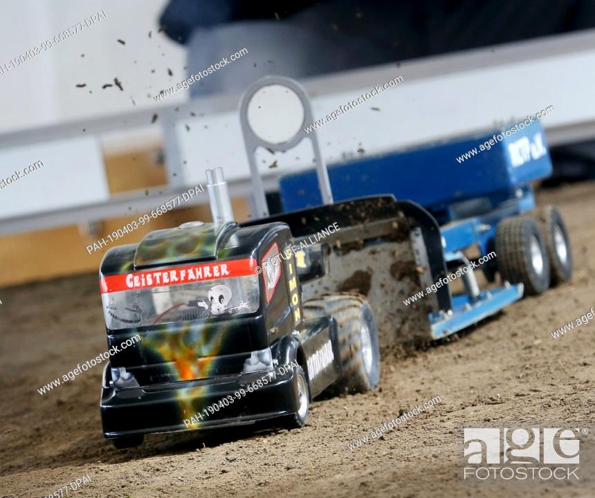 Stock Photo: 03 April 2019, North Rhine-Westphalia, Dortmund: The micropulling truck ""Geisterfahrer"" is throwing up a lot of dirt during the preview of the world's largest.