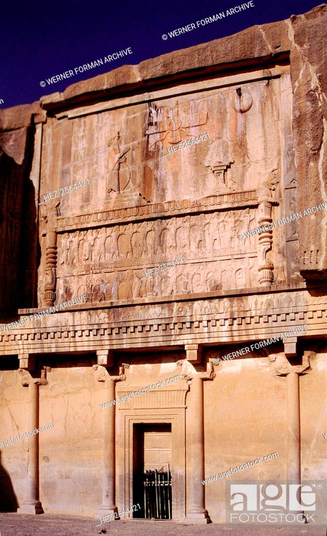 Stock Photo: The tomb of Darius I. The king's hand is raised in a gesture of worship. Above him is the winged disk of Ahuramazda, the god of Zoroastrian religion.