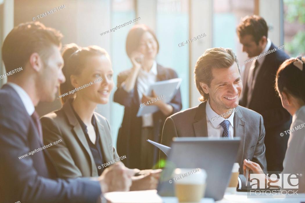 Stock Photo: Smiling business people in meeting.