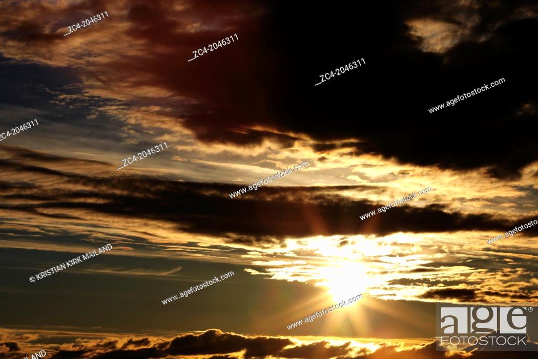 Stock Photo: Dramatic sunrise in cloudy sky. Scandinavia.