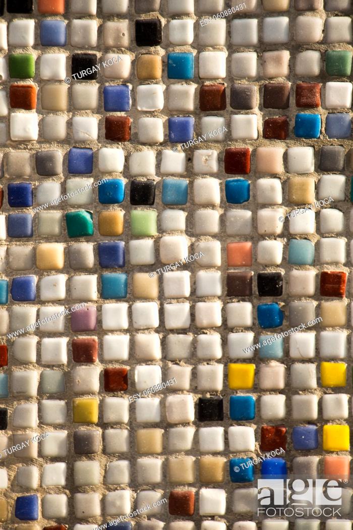 Stock Photo: concrete wall is covered with colorful mosaic.