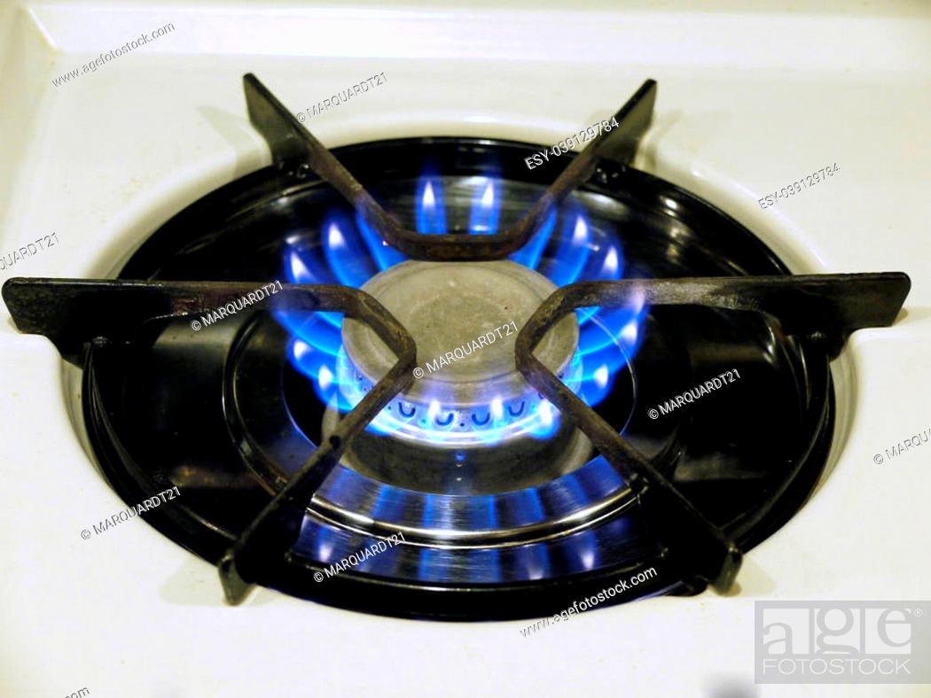 Stock Photo: A image of a propane gas stove top burnerthat is lit.