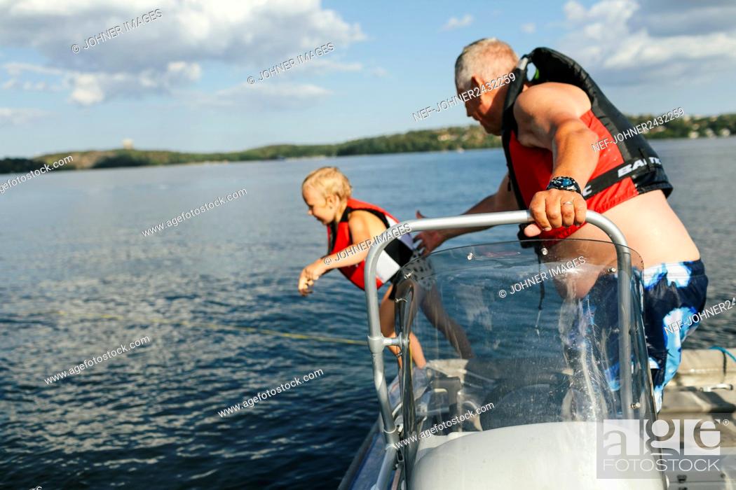 Stock Photo: Grandfather with granddaughter on boat.
