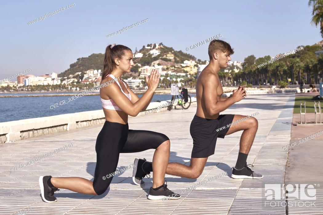 Stock Photo: Young man and woman athletes practice relaxation.