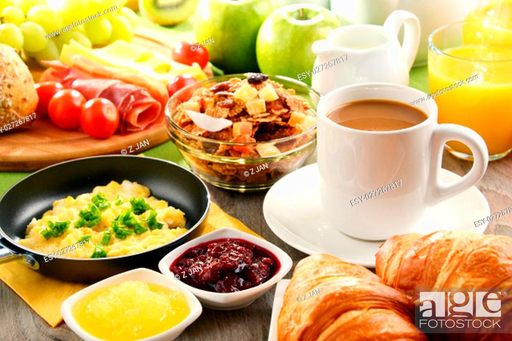 Stock Photo: Breakfast served with coffee, orange juice, egg, rolls and honey. Balanced diet.