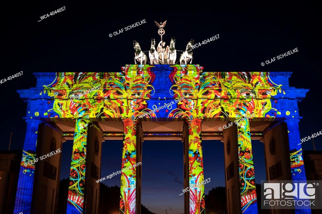 Stock Photo: Berlin, Germany, Europe - The illuminated Brandenburg Gate in Mitte district shines in bright colours during the 18th Festival of Lights according to this.