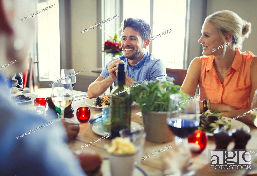 Stock Photo: Smiling couple dining at restaurant table.