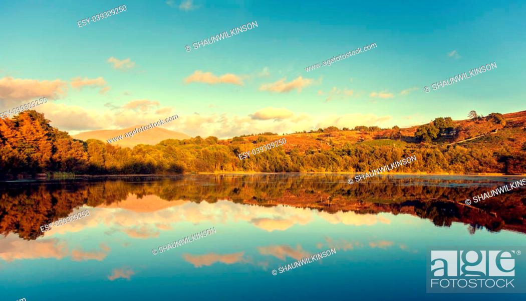 Stock Photo: view of lakes with mountains and relection at sunset.