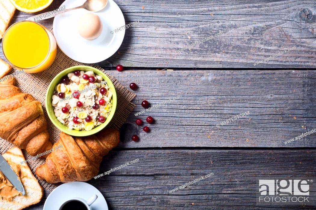 Stock Photo: Breakfast including coffee, egg, croissant, orange juice, muesli and bread.