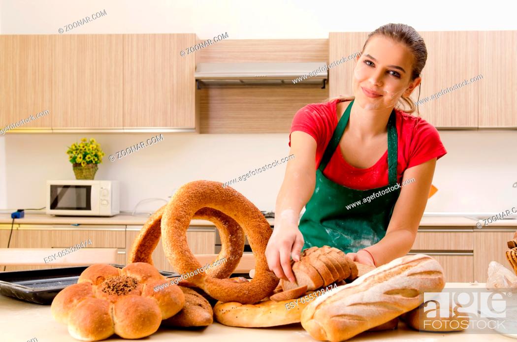 Stock Photo: Young female baker working in kitchen.